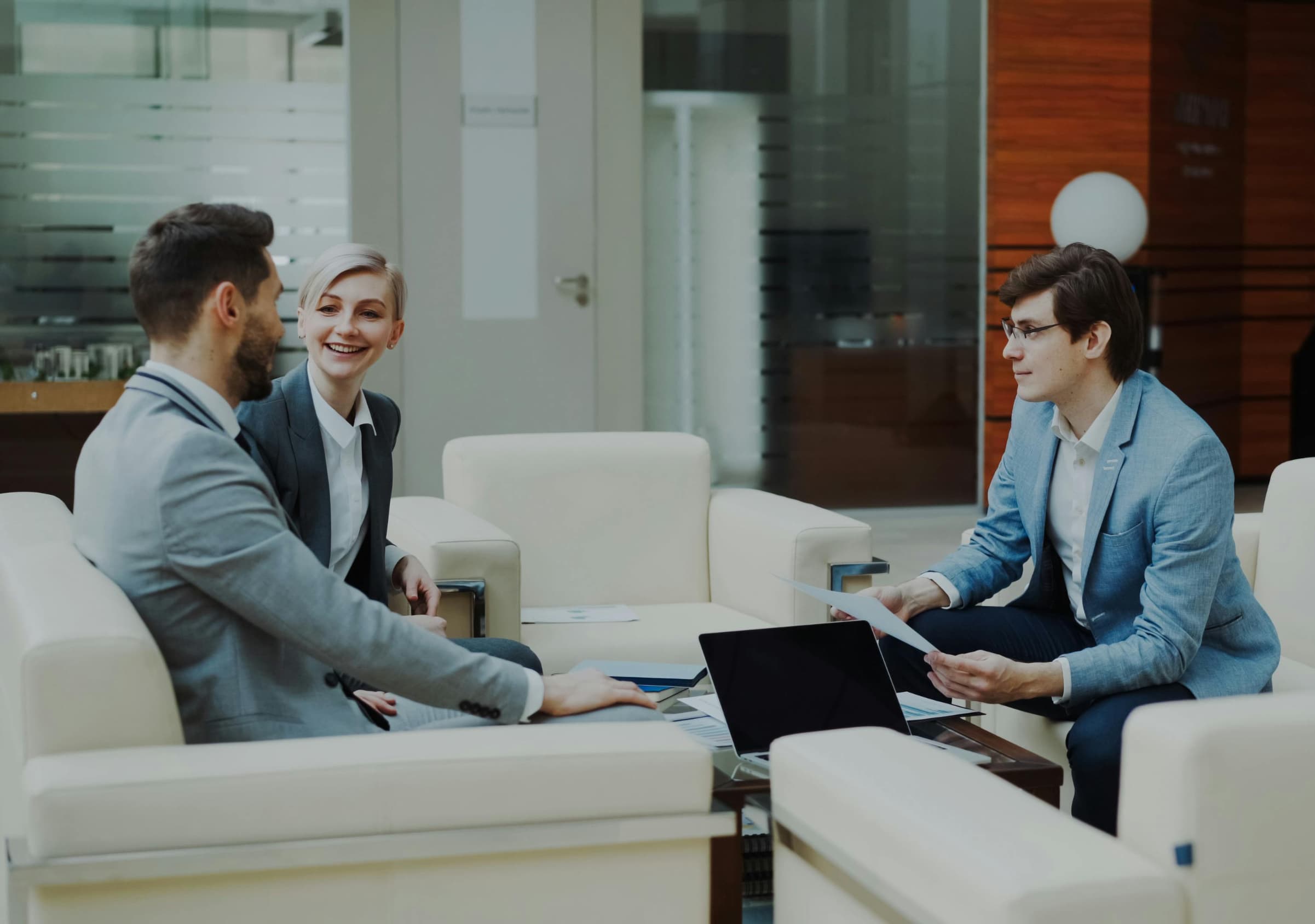 Advisors meeting with a client in a modern office
