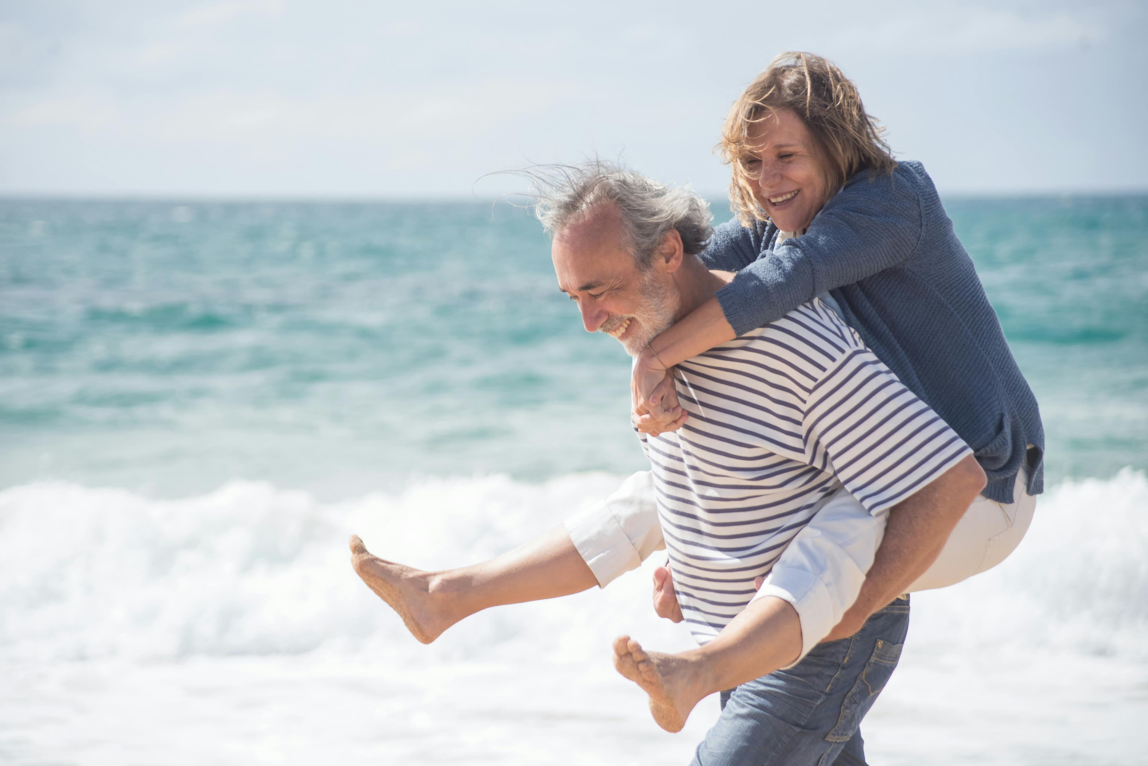 Older couple enjoying a carefree moment at the beach